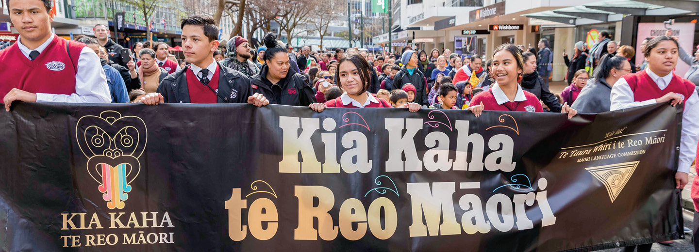 Image of students marching to celebrate a language