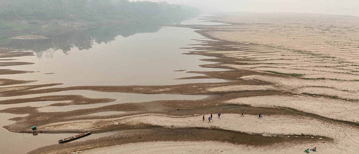 people crossing a dry river