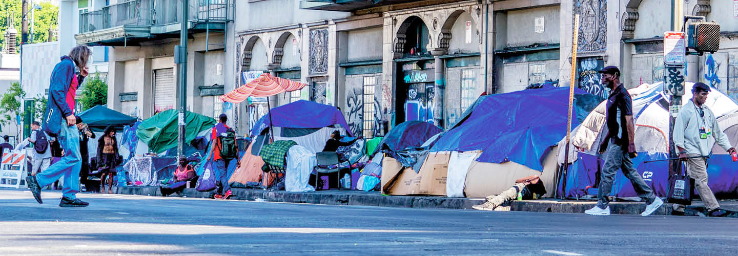 a row of tents set up as a homeless encampment
